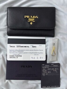 Authentic Prada Black Saffiano Leather Trifold Wallet with Gold Logo key holder